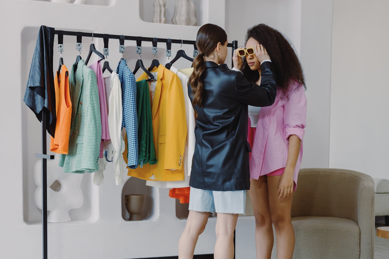 home-hero-bg Fashion stylist assists client in a vibrant wardrobe fitting, ensuring perfect accessory choices.